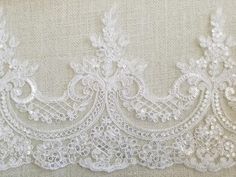 white lace on fabric with flowers and leaves