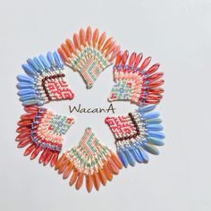 four different colored beads with the words wacan written in front of them on a white surface