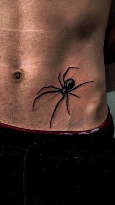 a man with a spider tattoo on his stomach