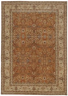 an orange and beige rug with floral designs