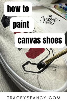 paint brush painting a school logo on white canvas shoes - Canvas Shoe Painting, Paint Canvas Shoes, How To Paint Canvas, Customized Canvas Shoes, Christmas Shoes Diy, Embroidery Shoes Diy, Canvas Shoes Diy, Upcycle Shoes, Whimsical Shoes