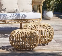 two wicker stools sitting on top of a wooden deck