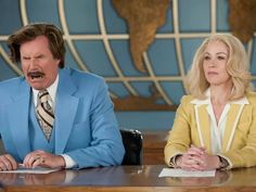 two people sitting at a table in front of a globe