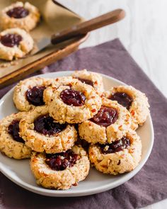 a plate full of cookies with jam on top