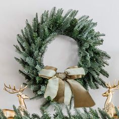 a christmas wreath with two deer heads on it