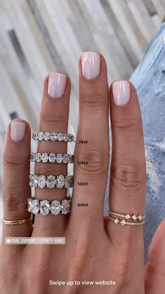 a woman's hand with five different rings on it and the width of her fingers