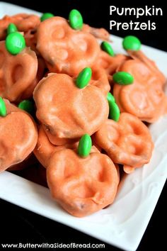 a white plate topped with candy shaped like pumpkins