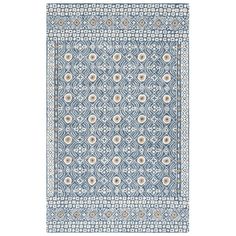 a blue and white rug with an intricate design on the bottom, in front of a white background