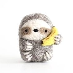 a small stuffed slotty holding a banana