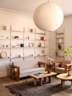 a living room filled with furniture and shelves