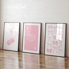 three framed art prints on the wall above a wooden floor