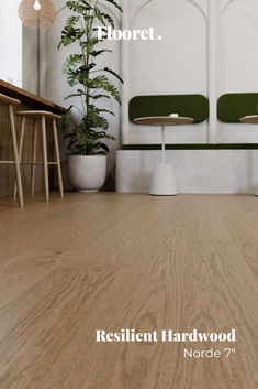 The picture shows Norde 7", a color from Flooret Silvan Resilient Hardwood Collection. Norde has notes of caramel latte, walnut, and sepia create a grounded floor reminiscent of your favorite coffee shop on a rainy day, novel in hand. Pairs well with plenty of greenery. Norde is seen in a beautiful Scandinavian style space with decor and furniture in tones of grey, white and medium wood. It's a great choice for the space and made all the elements flow perfectly in each room. Coffee Shop Flooring, Resilient Flooring, Caramel Latte, On A Rainy Day, Engineered Hardwood Flooring, Flooring Options, Hardwood Flooring, A Rainy Day, Engineered Hardwood