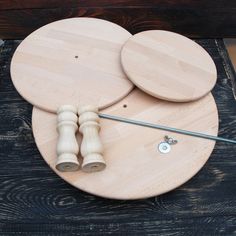 two circular wooden boards on top of each other with one piece of wood next to them