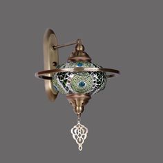 a wall light with an ornate design on the front and back of it's arm