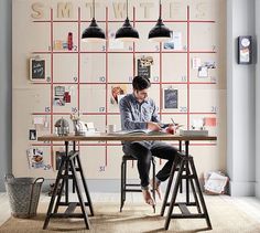 a man sitting at a desk writing on a piece of paper