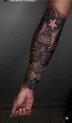 a man's arm with a lighthouse and stars tattoo on the left side of his arm