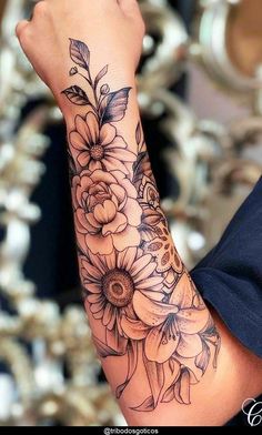 a woman's arm with flowers on it