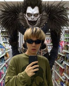 a person standing in a store looking at a cell phone with an evil monster behind them