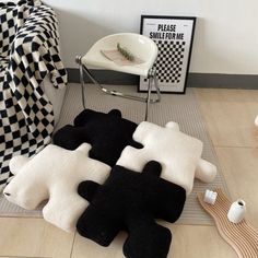 black and white rugs are on the floor next to a chair