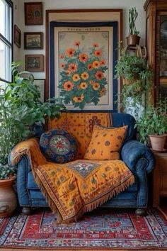 a living room filled with lots of plants next to a blue couch covered in pillows