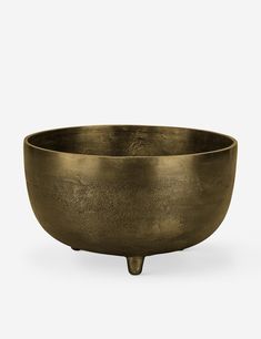 a large brass bowl sitting on top of a table