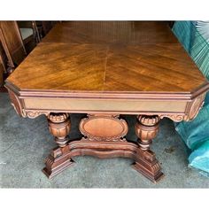 an old wooden table sitting on top of a carpeted floor