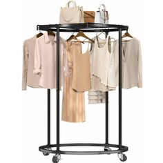 an ironing rack with clothes and handbags on it