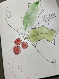 a piece of paper with watercolor and ink on it that has leaves and berries