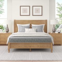 a large bed sitting in a bedroom next to two framed pictures on the wall above it