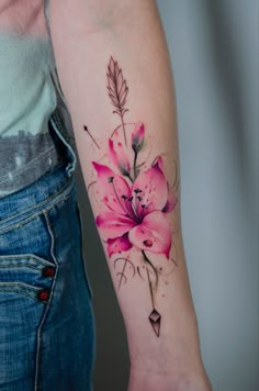 a woman with a pink flower tattoo on her arm