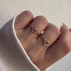 A timeless classic with a twist, this stunningly unique 14K Gold Heart Love Knot Ring is the perfect way to win the heart of a loved one or to enjoy yourself. Shined to a perfect luster and delicate enough to wear everyday, you will never want to take this beauty off! 

Size: 7mm (H) x 1.1mm Wire Band
Solid 14K Gold
Lifetime Guarantee
Made in Los Angeles Solid Gold Rings Unique, Dainty Heart Ring Gift Tarnish Resistant, Tiny 14k Gold Heart Ring For Gift, Minimalist Gold Heart Ring With Polished Finish, Heart-shaped Metal Ring Jewelry For Gifts, Heart Knot Ring, Heart Knot, Love Knot Ring, Gold Heart Ring