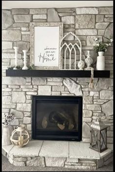 a fireplace with a stone mantle and shelves above it