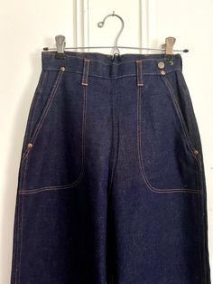 RARE Blue Bell (Wrangler Denim Co.) 1950s with Classic Side Zip! BRAND NEW Vintage Deadstock! Dark Denim w/ Orange stitching, 2 Front Pockets & 1 Back Pocket. Side Zip w 2 Snaps for Adjusting Waist. SIZE: Misses 12 (See Tag) These are "Misses" but might fit XXSmall Petite.  *Approximate* flat measurements: Waist flat across: 12"; Hips flat across: 18"; Leg opening: 8.5"; Inseam: 29"; Length: 43"  Denim History! Great for Vintage Store Display! Retro Dark Wash Bottoms With Pockets, Retro Blue Jeans With Patch Pockets, Vintage Dark Wash Bottoms With Patch Pockets, Vintage Denim Blue Jeans With Pockets, Vintage Blue Jeans With Patch Pockets, Vintage Denim Blue Bottoms With Pockets, Vintage High Rise Jeans With Patch Pockets, Vintage High Rise Bottoms With Pockets, Vintage Indigo Rigid Denim Jeans