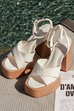 A summer spent with the D'Amelio Footwear Raela White Eyelet Embroidered Platform Ankle Strap Sandals is a summer spent in sensational style! These too-cute sandals start with a raffia-wrapped, 1.5"" toe platform that creates a square footbed, along with floral eyelet embroidered vamp straps that crisscross atop an open-toe upper. A supportive heel strap holds an adjustable ankle strap that secures with a white buckle, all above a matching raffia-wrapped, sky-high block heel. 5" raffia-wrapped h Closed Toe Lace-up Sandals For Beach Vacation, Summer Beach Lace-up Sandals With Ankle Strap, Summer Synthetic Closed Toe Sandals, Closed Toe Synthetic Summer Sandals, Casual Open Heel Lace-up Sandals For Vacation, Synthetic Closed Toe Summer Sandals, Summer Beach Lace-up Wedge Sandals, Closed Toe Synthetic Sandals For Summer, Summer Platform Lace-up Sandals With Block Heel