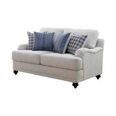 a white couch with blue pillows on it