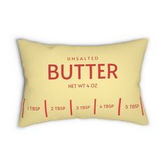 a yellow pillow with the words, unsalted butter on it and red lettering