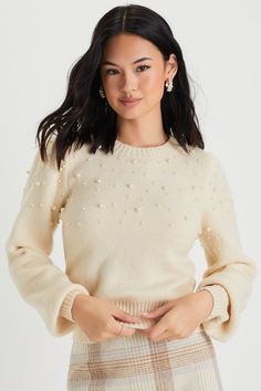 The Lulus Undeniable Glow Ivory Pearl Pullover Sweater will be your favorite way to make yourself shine this holiday season! This stunning sweater has a slightly fuzzy medium-gauge knit construction, with gleaming faux pearl details throughout, that shapes a classic crew neckline, long balloon-style sleeves with fitted cuffs, and a relaxed bodice. Contrasting ribbed knit accents the neckline, cuffs, and hem. Fit: This garment fits true to size. Length: Size medium measures 17.75" from shoulder t Winter Cream Crew Neck Knit Top, Cream Crew Neck Knit Top For Winter, Cream Winter Party Top, Cream Party Tops For Winter, Beige Winter Party Sweater, Elegant Cream Knit Top For Winter, Pearl Sweater Outfit, Fancy Sweater, Pearl Sweater