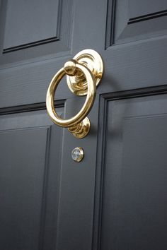 a close up of a door handle on a black door with a diamond in the middle