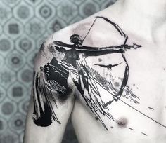 a man's chest with black ink on it and an artistic design in the upper half