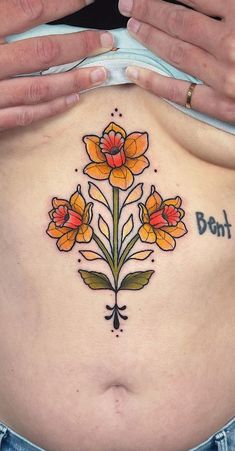 a woman's stomach with flowers on it and the words bont written in cursive writing