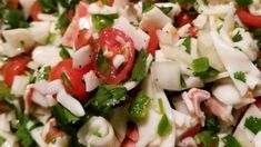 a salad with tomatoes, onions and green peppers on it is ready to be eaten