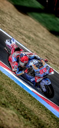 a person riding a motorcycle on a race track