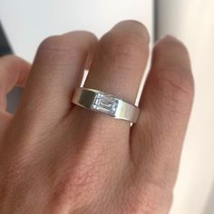 a woman's hand with a diamond ring on it