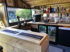 the inside of a small bar with lots of bottles