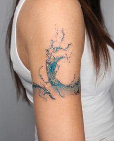 a woman's arm with a blue and white tattoo design on the left side of her arm