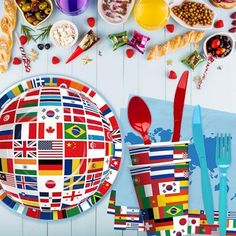 a table topped with lots of colorful plates and bowls filled with different foods on top of it