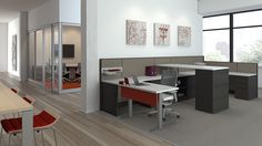 an office with desks, chairs and pictures on the wall