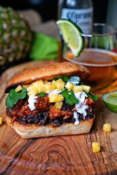 a sandwich with meat, pineapple salsa and sour cream