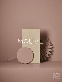 a book with the title mauve on it next to a paper sculpture that looks like a sunflower