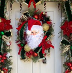 a christmas wreath with santa clause on it and decorations around the front door, along with other festive items